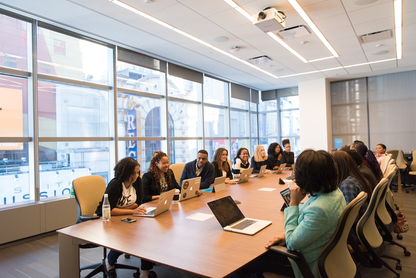 Diverse professionals collaborating around a conference table in a modern meeting room.
